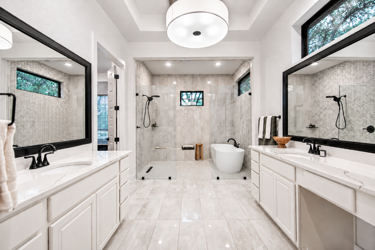 Bathroom floor and shower with white marble-look tiling 